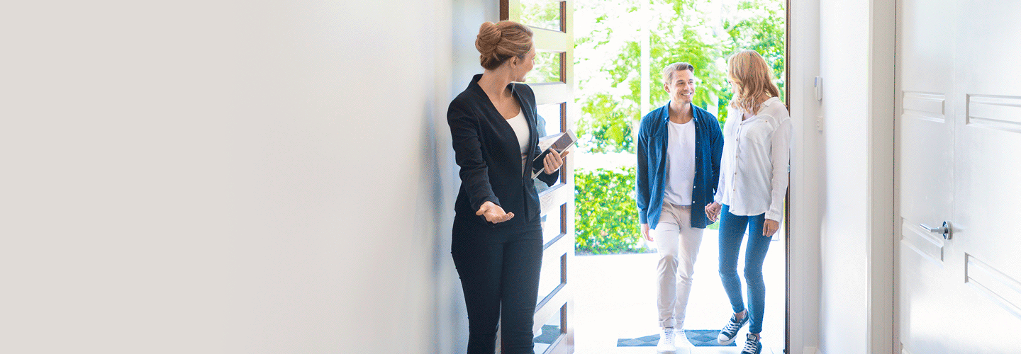 Couple meeting with a real estate agent in Adelaide while exploring home loan and refinancing options.