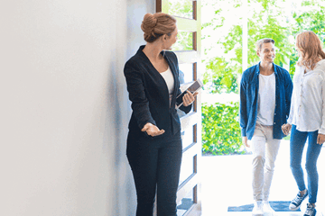 Couple meeting with a real estate agent in Adelaide while exploring home loan and refinancing options.