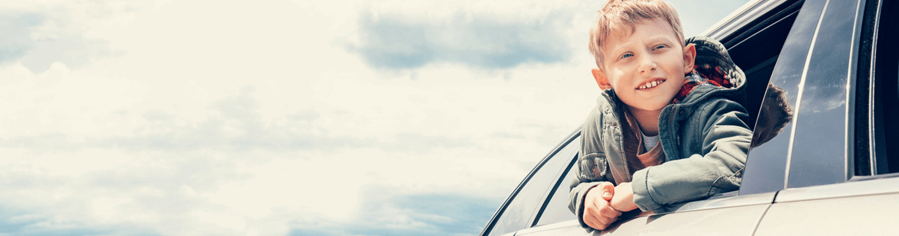 Young child enjoying scenic drive in family car