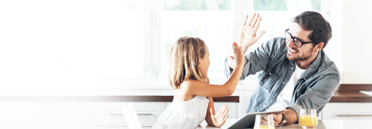 Father and daughter celebrating at home after securing a variable home loan in South Australia.