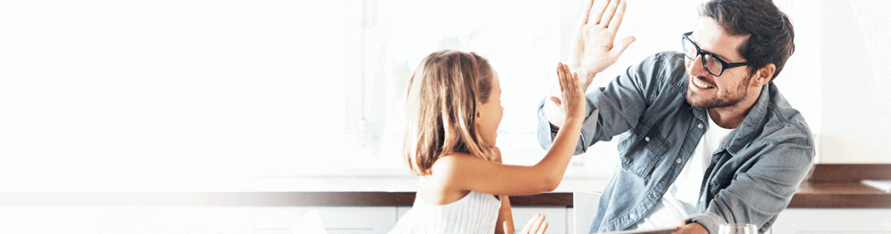 Father and daughter celebrating at home after securing a variable home loan in South Australia.