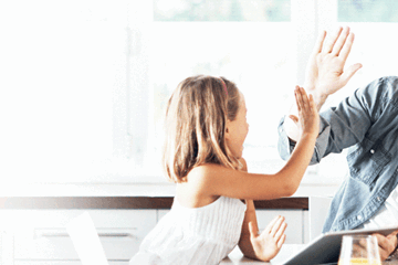 Father and daughter celebrating at home after securing a variable home loan in South Australia.